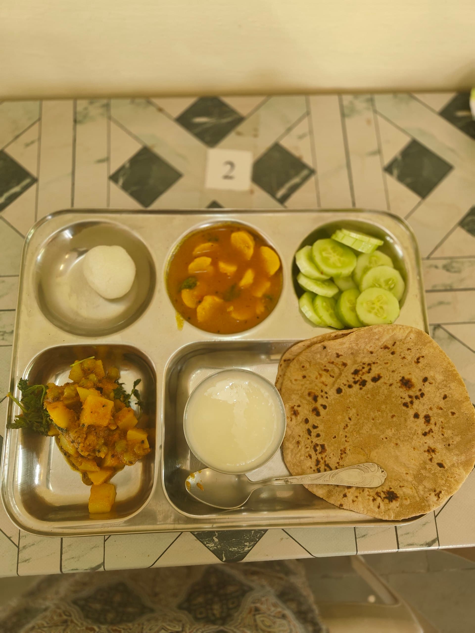 A satvik meal with chapati, vegetables, cucumber, and curd
