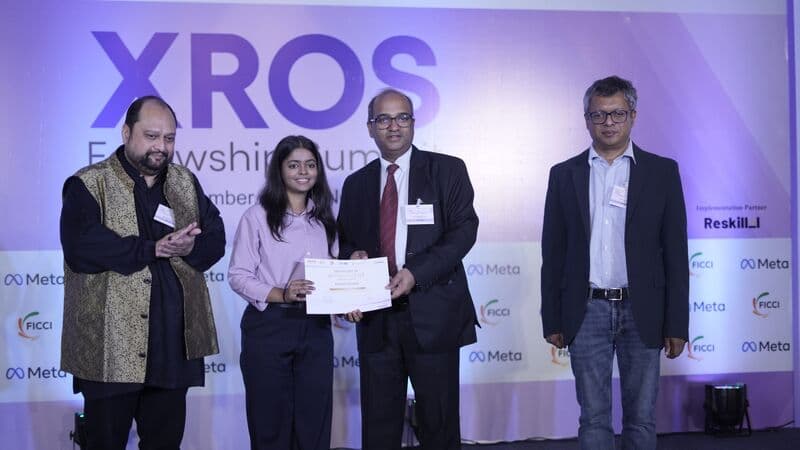 Bhawna Chauhan receiving her certificate on stage at the XROS Fellowship Summit